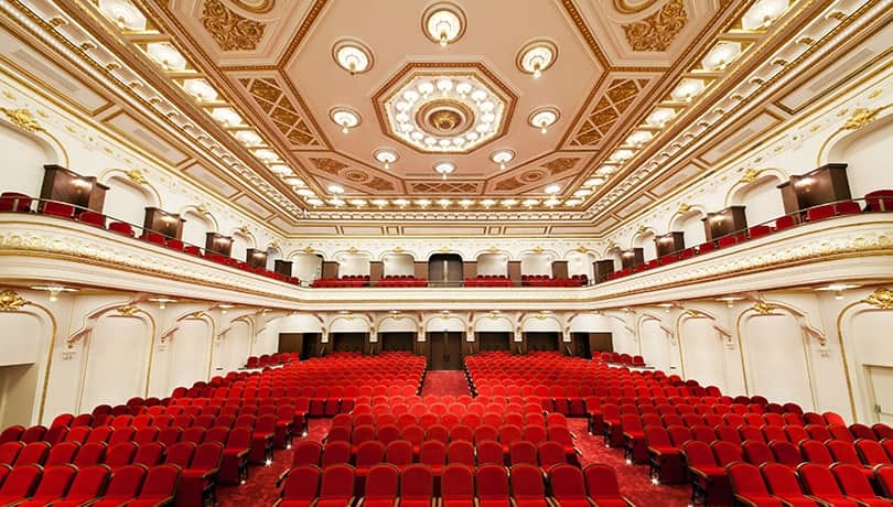 Tiered ballroom at AKM auditorium for grand presentations and award ceremonies.