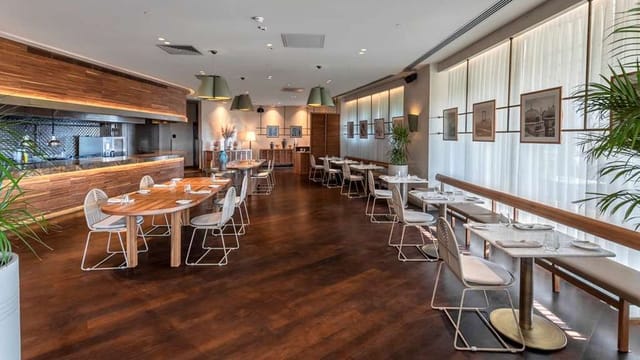 Contemporary event space with modular tables for corporate luncheons and business meetings.