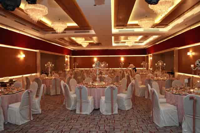 Elegant ballroom with tiered chandeliers for formal wedding and gala event seating.