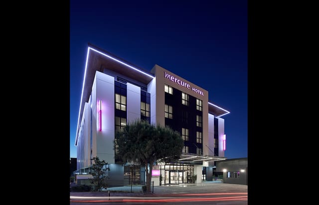Mercure Istanbul Altunizade modern hotel exterior at dusk for corporate meetings and conferences.