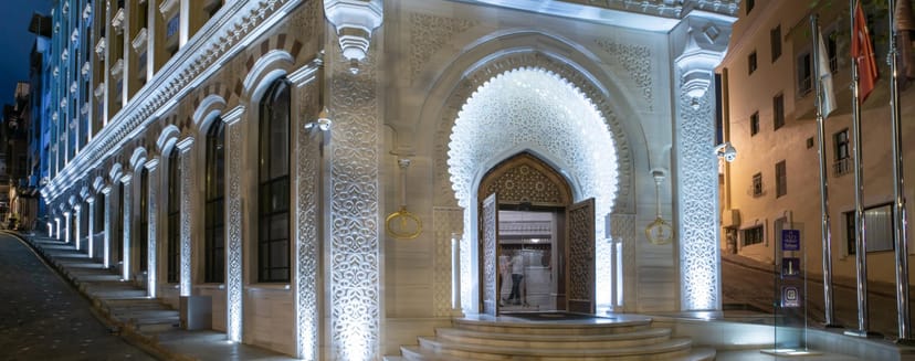 Luxury AJWA Sultanahmet library facade with dramatic lighting for upscale gala or evening reception.