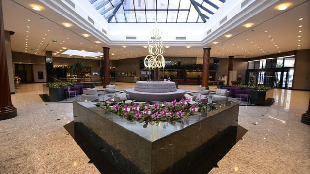 Elegant dinner theater in Grand Cevahir Hotel atrium for luxury corporate events and conferences.