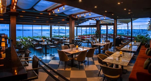 Rooftop meeting room with retractable roof for executive networking and corporate events.