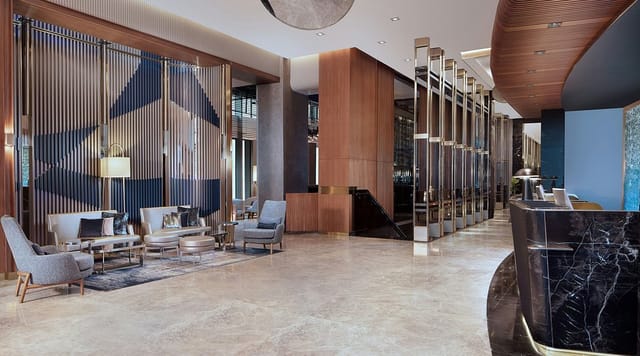 Luxury hotel lobby for executive event registration and premium networking breakout.