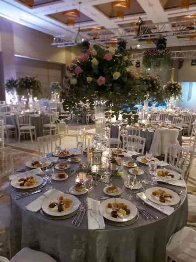 Elegant ballroom at Hilton Kozyatağı with floral centerpieces for formal gala or wedding reception.
