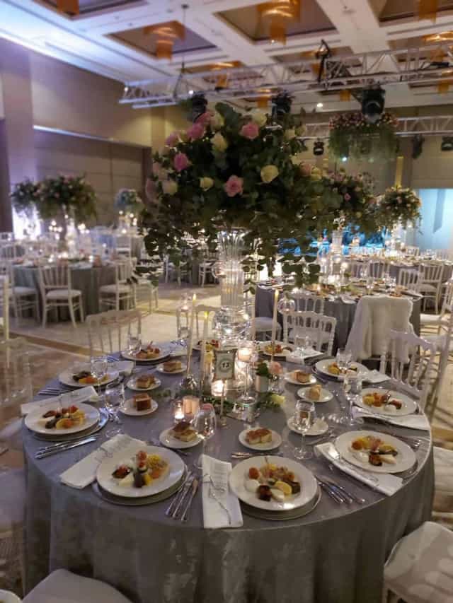 Elegant ballroom at Hilton Kozyatağı with floral centerpieces for formal gala or wedding reception.