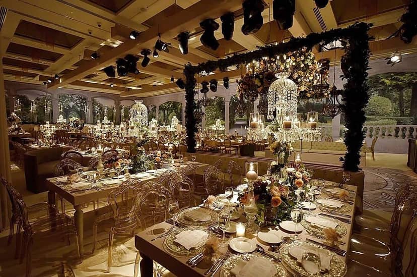 Luxury gala banquet hall at Hilton Kozyatağı with crystal floral centerpieces and stage lighting.