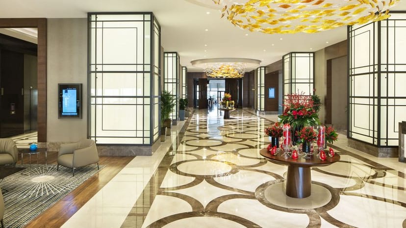 Luxury corporate event registration area at Sheraton Grand Istanbul Atasehir, professional lighting.