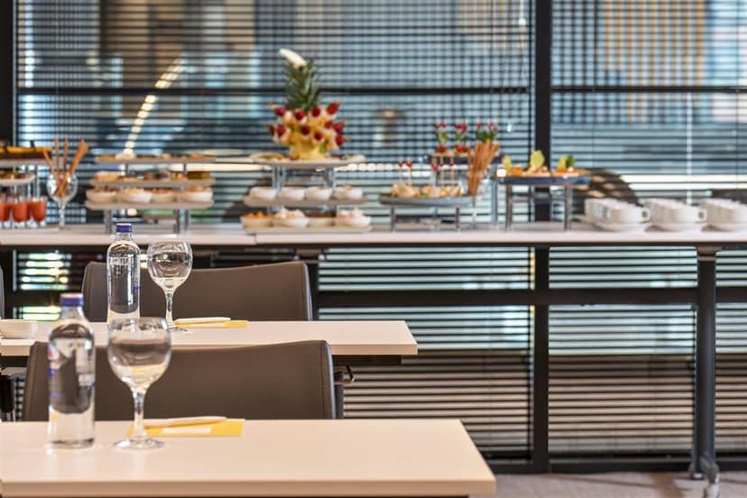 Classroom-style breakout room with catering buffet at Crowne Plaza Istanbul for corporate meetings.