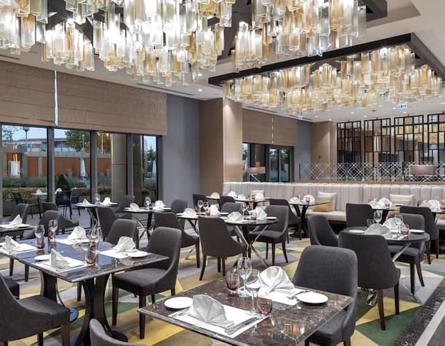 Upscale Hilton Istanbul Bakirkoy banquet hall with statement lighting for corporate events.