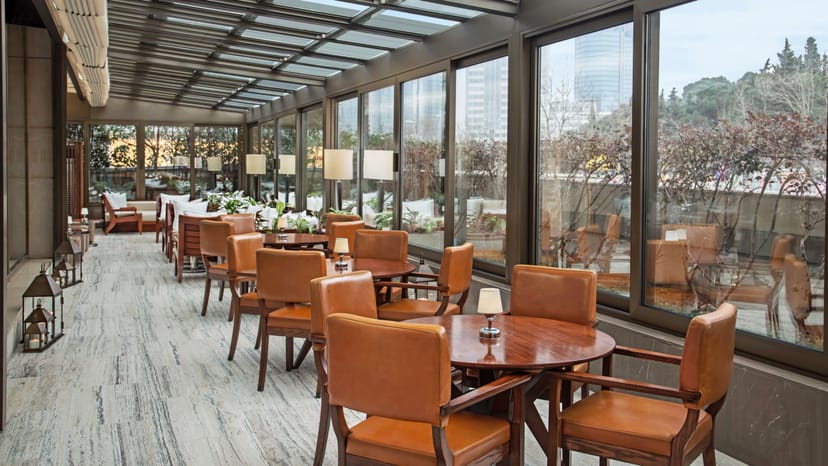 Upscale restaurant venue with glass walls for corporate meetings and VIP networking events.