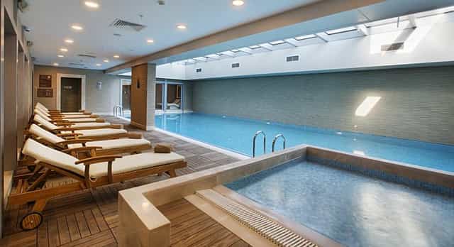 Modern indoor hotel pool and spa at Dedeman Bostancı for business conference wellness.