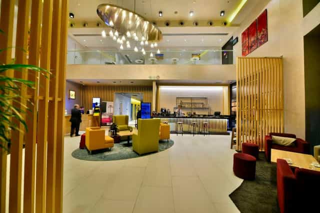 Modern Park Inn Istanbul hotel lobby with bar, ideal for corporate event check-ins and networking.
