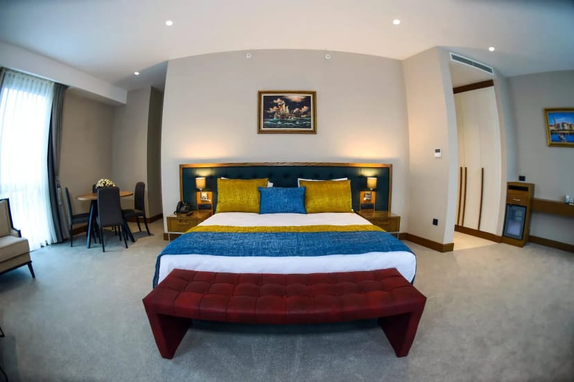Mon Cher Hotel guest room, clean functional space for conference lodging and business travel.