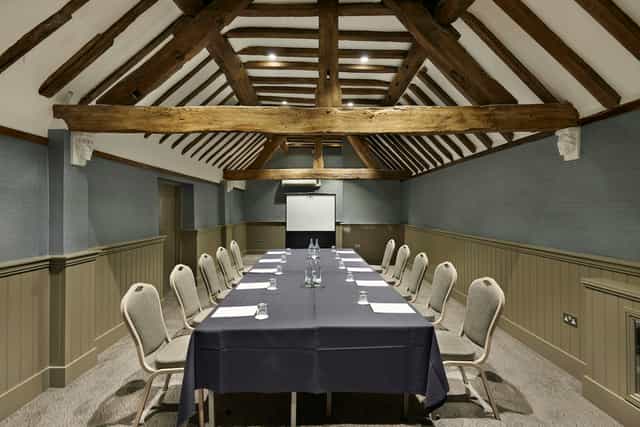 Woodland Suite boardroom with rustic exposed beams for corporate meetings and event hire.