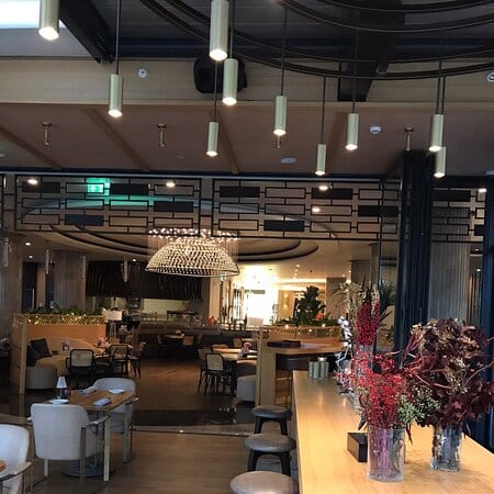 Upscale restaurant interior with warm lighting, ideal for networking events and cocktail receptions.