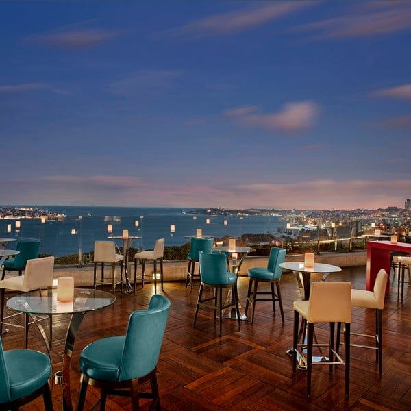Summit Bar & Terrace rooftop banquet hall with sunset backdrop for corporate networking events.