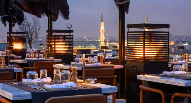 Rooftop restaurant with fire features for corporate receptions and high-end incentive dinners.
