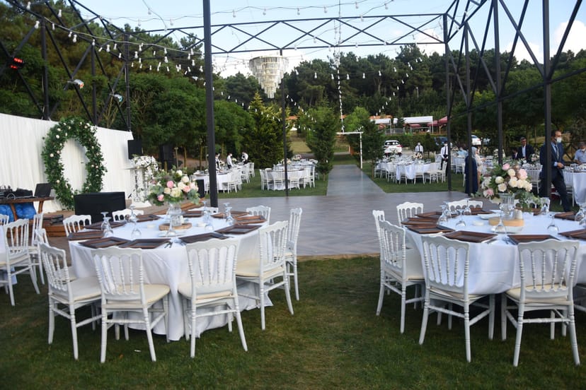 Elegant open-air event space with bistro lighting, perfect for wedding reception or corporate gala.