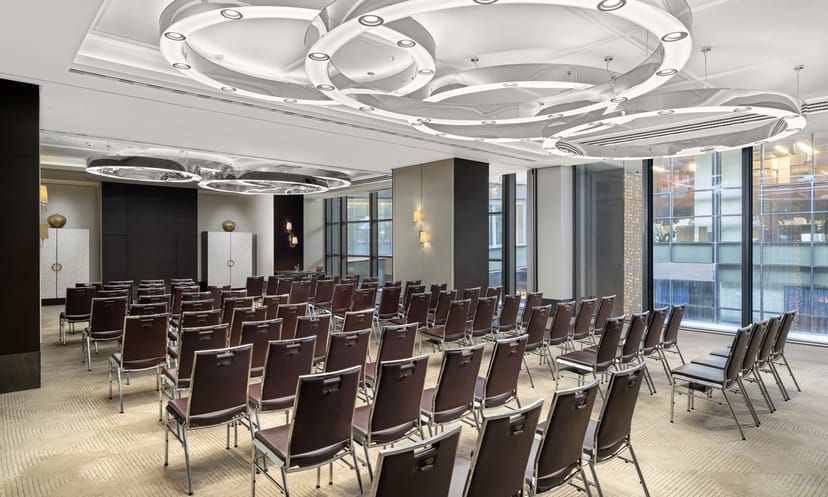 Vela meeting room with sculptural ceiling and floor-to-ceiling windows for corporate conferences.