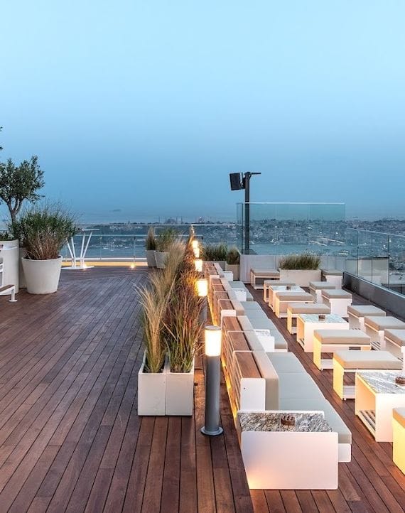 High-end rooftop bar with lounge seating for sunset cocktail receptions and networking events.