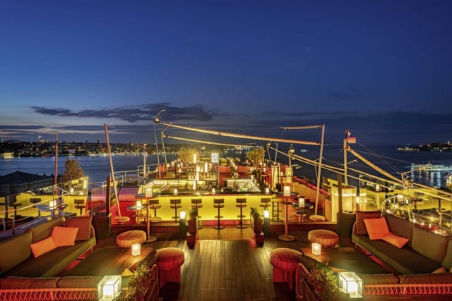 Rooftop restaurant with tiered lounge seating for corporate networking and evening reception events.