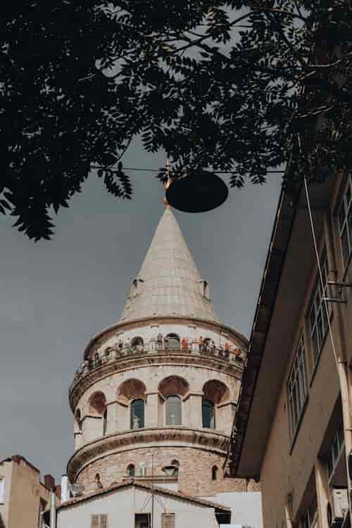 Crowded Galata Tower observation deck, historic landmark, Istanbul sightseeing, travel photography.