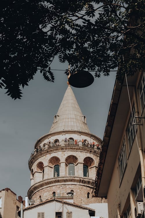 Crowded Galata Tower observation deck, historic landmark, Istanbul sightseeing, travel photography.