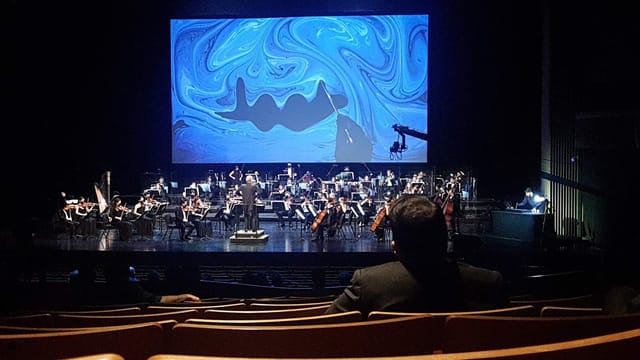 Orchestra performing at Vestel Amp keynote event with immersive digital AV integration.