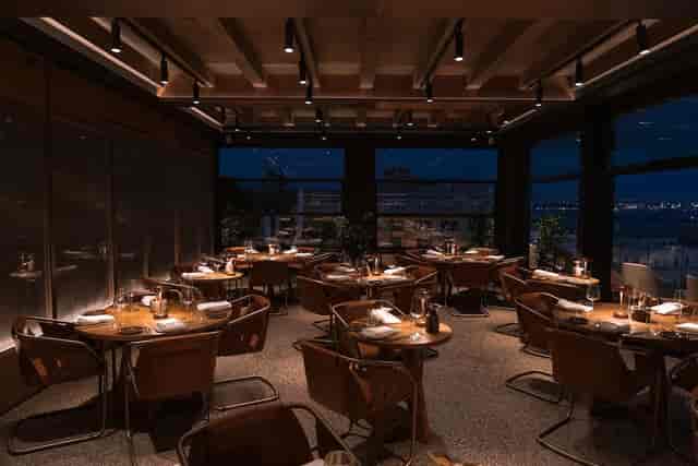Serica Restaurant dining room for corporate dinner or networking event with round tables.