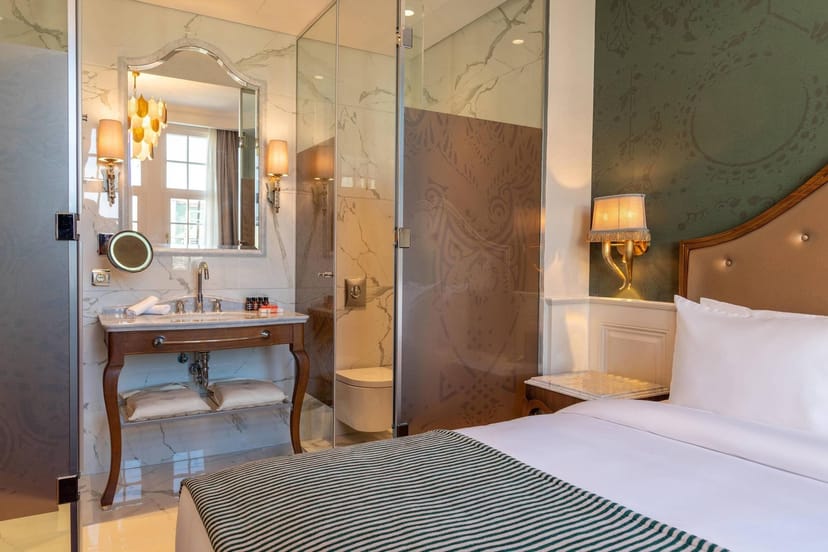 Orientbank Hotel Istanbul guest room with glass-enclosed vanity for luxury corporate event housing.