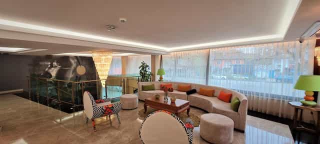 Modern corporate networking suite at Tuzla Garden Hotel & Spa with bold accent furniture.