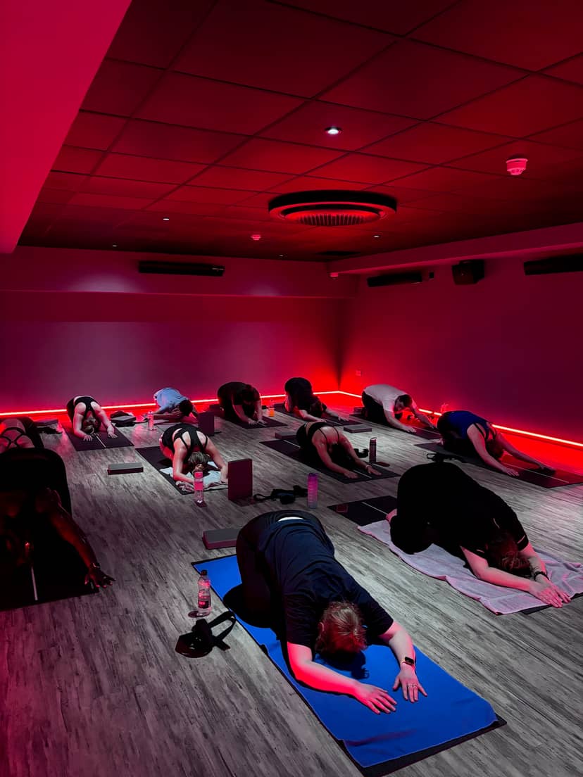Wellness breakout session in a yoga studio with atmospheric mood lighting for corporate events.