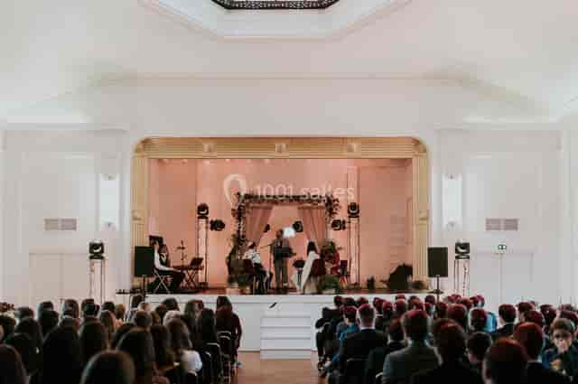 Theater-style stage in historic ballroom for corporate conference and event venue.