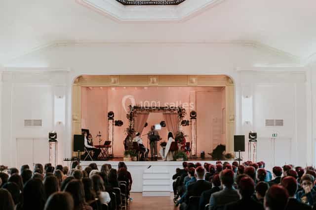 Theater-style stage in historic ballroom for corporate conference and event venue.