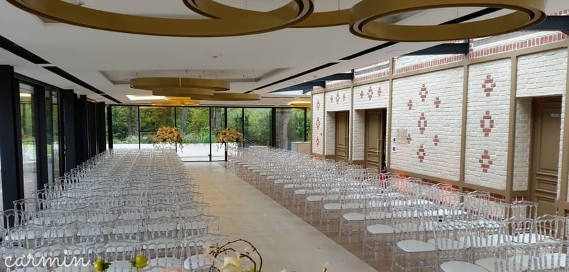 Elegant Pavillon Royal event venue with ghost chairs, perfect for luxury ceremonies and presentations.