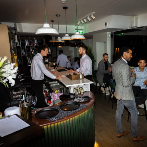 Corporate networking reception with mood lighting at Simul Place event venue.