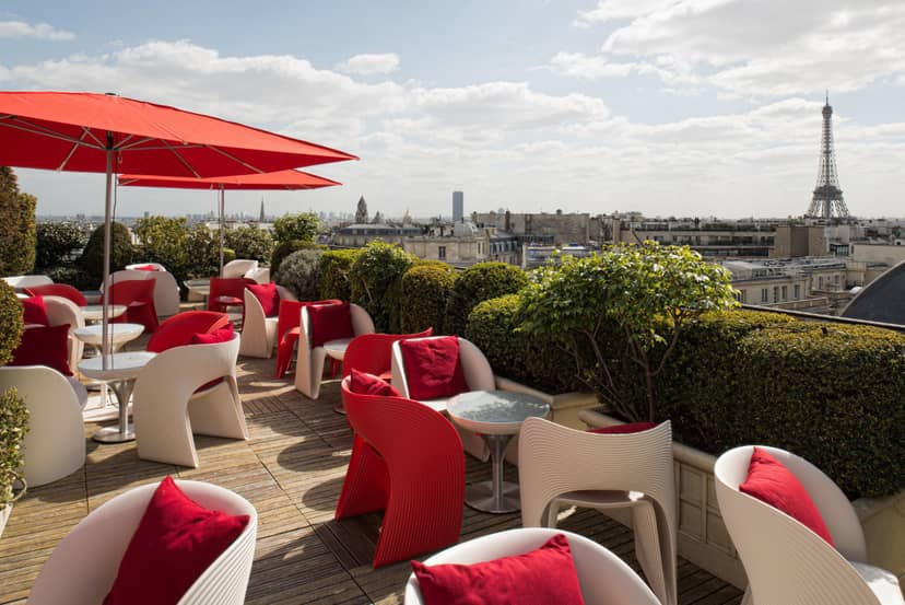 Rooftop lounge with Eiffel Tower view for VIP corporate events and networking receptions.