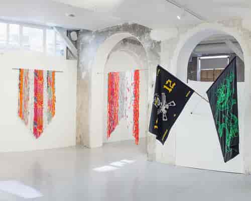 Industrial-chic L'Atelier gallery with stone arches for art pop-ups and brand activations.