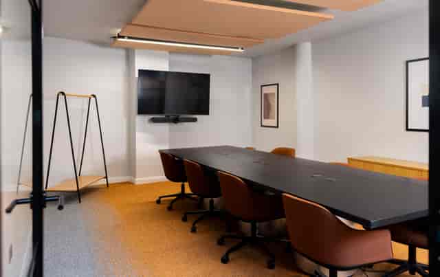 The Studio Suite huddle room with AV setup for hybrid meetings and professional team collaboration.