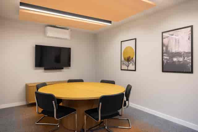 The Studio Suite breakout room with round table for small-group collaboration and AV connectivity.