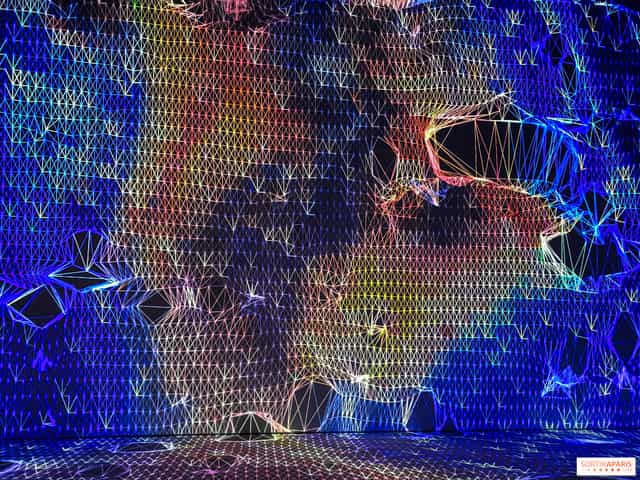 Digital keynote backdrop at Grand Palais Immersif with abstract tech textures for event branding.