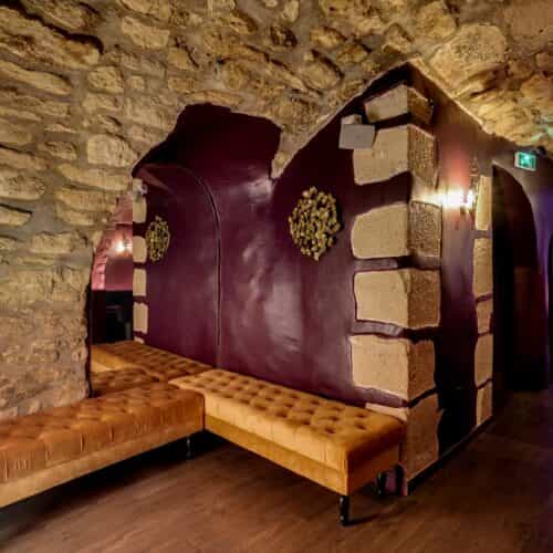Maison Faust banquet hall with stone walls, ideal for VIP receptions and intimate networking events.
