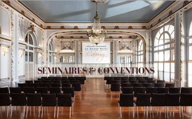 Theater-style meeting room at Grand Hôtel de Normandie for corporate events and executive briefings.