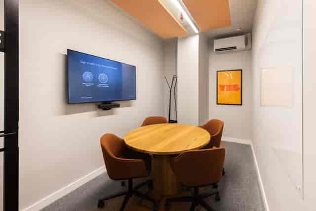 Modern Meeting Room C with tech setup for hybrid team collaboration and breakout sessions.