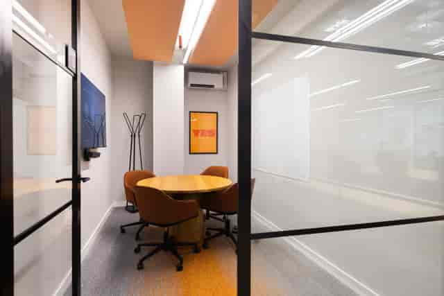 Modern huddle room with integrated display for private team syncs and virtual meetings.