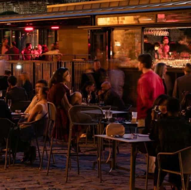 Evening reception bar at Le Son de la Terre with ambient lighting for networking event.