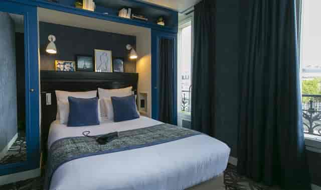Stylish boutique hotel room near Arc de Triomphe for business travel.