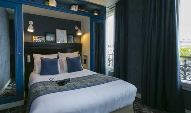 Stylish boutique hotel room near Arc de Triomphe for business travel.