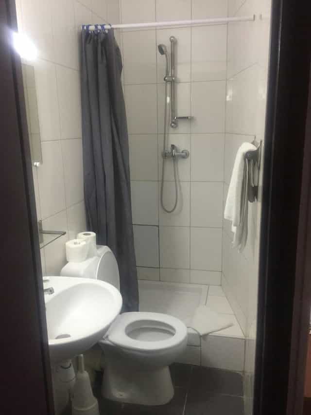 Compact Hotel Chevallier bathroom, budget event lodging, professional site inspection photography.